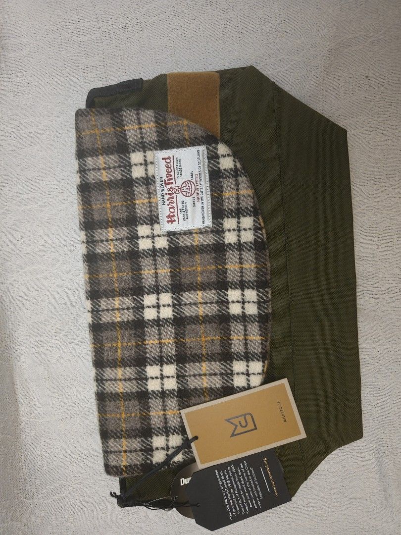 DuraTweed Harris Tweed Messenger Bag (Category: Sling Bags) located in Makati City. Submitted by emem.pre.owned.ph (Listing ID 1433889119, Image 1). Description: - Harris Tweed plaid flap - Durable olive green body - Multiple interior pockets (including a zippered compartment) - Adjustable shoulder strap - Secure flap closure - Brown leather accent - "DuraTweed" tag.