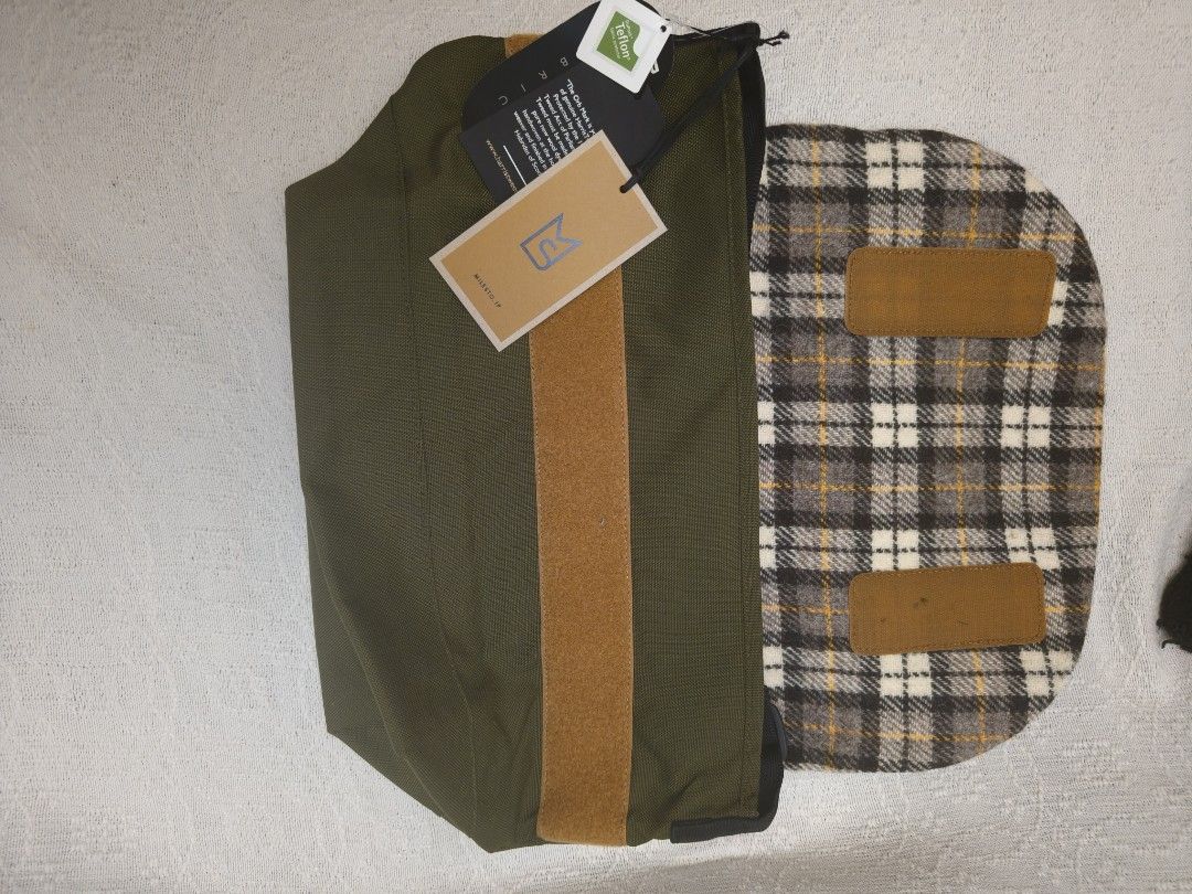 DuraTweed Harris Tweed Messenger Bag (Category: Sling Bags) located in Makati City. Submitted by emem.pre.owned.ph (Listing ID 1433889119, Image 2). Description: - Harris Tweed plaid flap - Durable olive green body - Multiple interior pockets (including a zippered compartment) - Adjustable shoulder strap - Secure flap closure - Brown leather accent - "DuraTweed" tag.