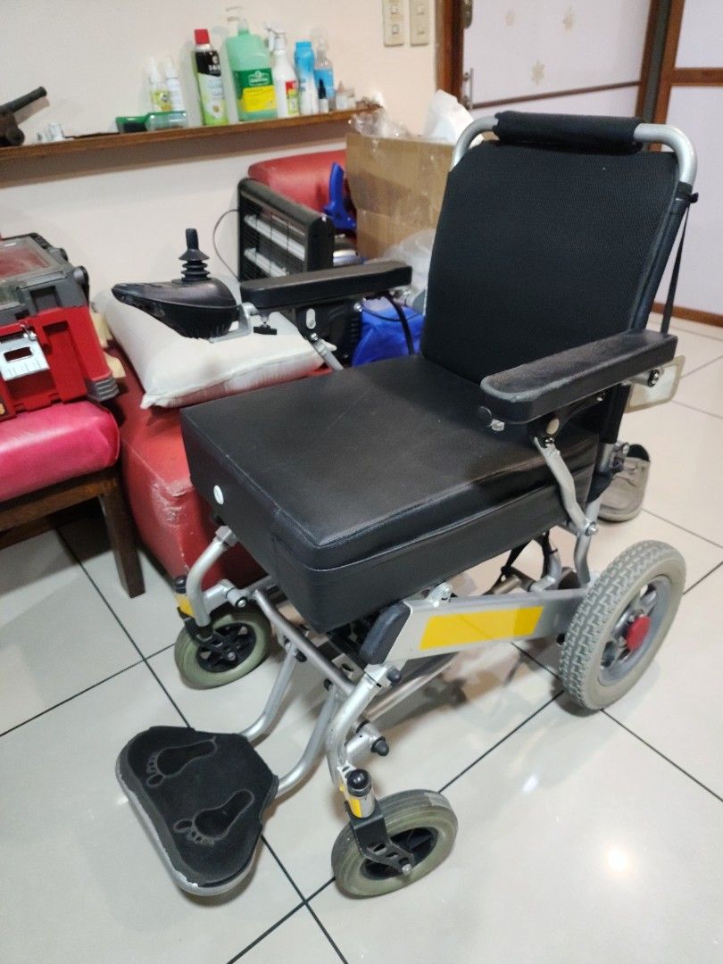 Electric Wheelchair with Footrest (Category: Wheelchairs) located in Manila. Submitted by binbot (Listing ID 1433856645, Image 1). Description: - Electric wheelchair - Black seat and backrest - Comfortable armrests - Footrests with foot imprints - Easy-to-use joystick control - Sturdy metal frame - Four-wheel design (2 large rear wheels, 2 smaller front wheels).