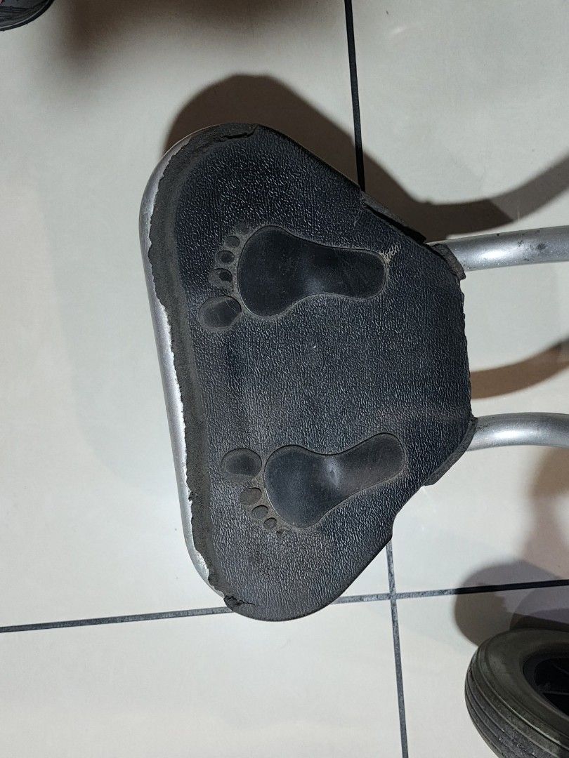 Electric Wheelchair with Footrest (Category: Wheelchairs) located in Manila. Submitted by binbot (Listing ID 1433856645, Image 3). Description: - Electric wheelchair - Black seat and backrest - Comfortable armrests - Footrests with foot imprints - Easy-to-use joystick control - Sturdy metal frame - Four-wheel design (2 large rear wheels, 2 smaller front wheels).