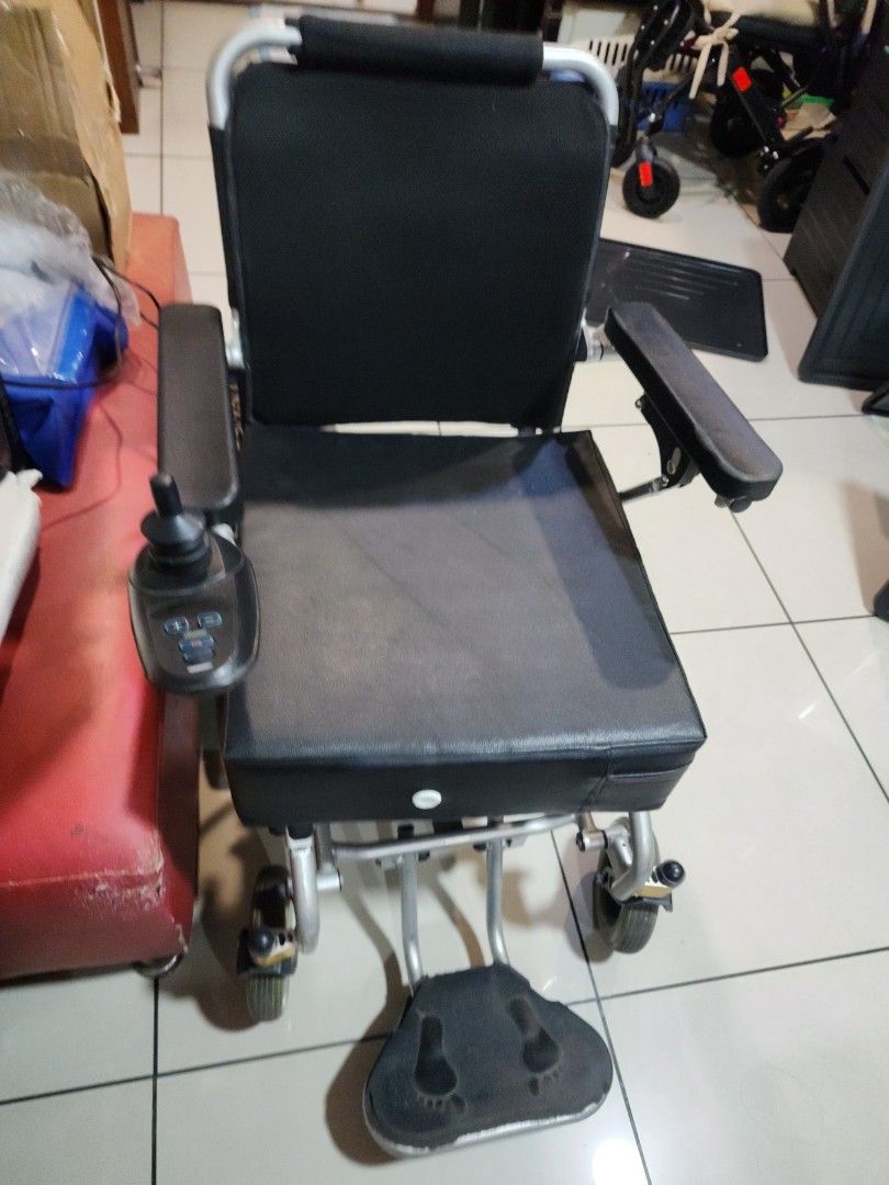 Electric Wheelchair with Footrest (Category: Wheelchairs) located in Manila. Submitted by binbot (Listing ID 1433856645, Image 2). Description: - Electric wheelchair - Black seat and backrest - Comfortable armrests - Footrests with foot imprints - Easy-to-use joystick control - Sturdy metal frame - Four-wheel design (2 large rear wheels, 2 smaller front wheels).