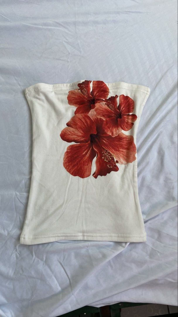 Floral Tube Top (Category: Others Tops) located in Manila. Submitted by cstdjyc (Listing ID 1433937030, Image 1). Description: - White tube top with vibrant floral print. - Features a straight neckline. - Fitted silhouette. - Design showcases large, red hibiscus flowers. - Made from soft, stretchy fabric. - Ideal for a casual, summery look..