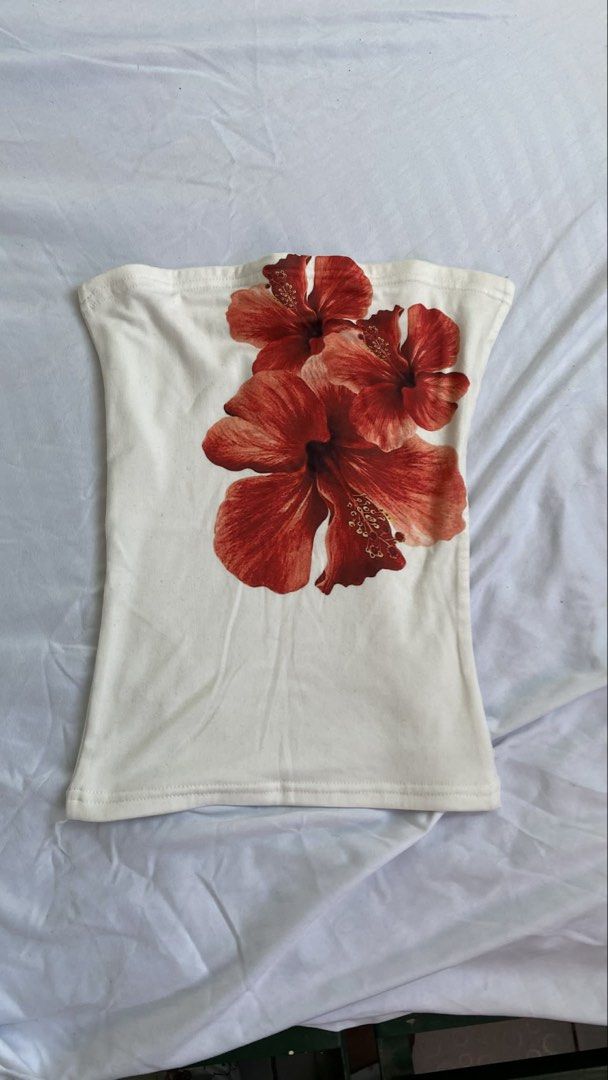 Floral Tube Top (Category: Others Tops) located in Manila. Submitted by cstdjyc (Listing ID 1433937030, Image 2). Description: - White tube top with vibrant floral print. - Features a straight neckline. - Fitted silhouette. - Design showcases large, red hibiscus flowers. - Made from soft, stretchy fabric. - Ideal for a casual, summery look..