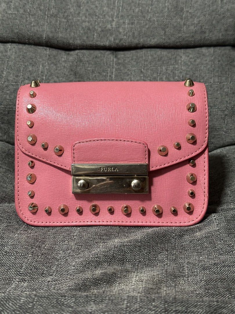 Furla Julia Mini Studded Crossbody Bag (Category: Luxury Bags & Wallets) located in Tarlac. Submitted by wearagainboutique (Listing ID 1433912820, Image 1). Description: - Authentic Furla crossbody bag - Color: Pink - Silver hardware - Studded details - Flap closure with Furla logo - Interior pocket - Chain strap - Made in Bulgaria - Rectangular shape - Textured finish -minimal signs of use -needs cleaning .
