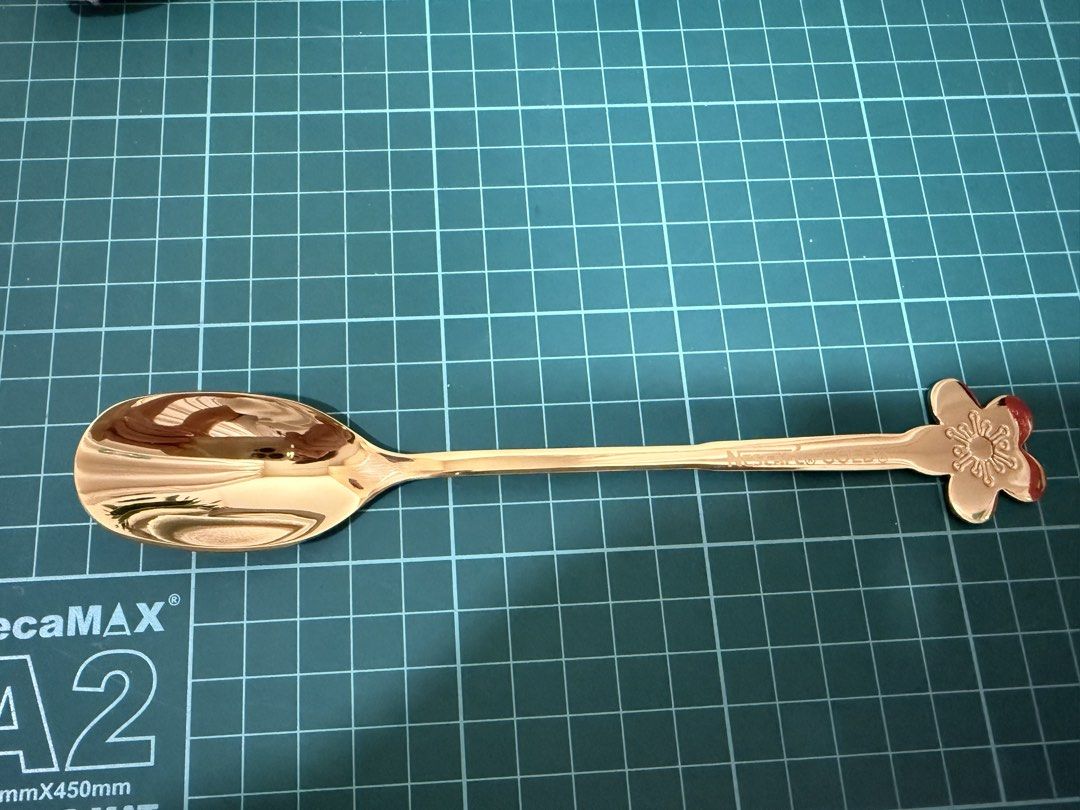 Gold Flower Spoon (Category: Dinnerware & Cutlery) located in Kuala Lumpur. Submitted by mamaCKMM (Listing ID 1433972798, Image 1). Description: Elegant gold spoon with a flower design at the end of the handle. The spoon has a shiny, reflective surface. The handle has the words "Nantucket Gold" engraved on it. Perfect for serving or as a decorative piece. Condition: 10/10.