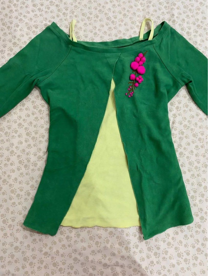 Green Top with Floral Embroidery (Category: Blouses) located in Santa Rosa. Submitted by honeyrackk (Listing ID 1433940135, Image 2). Description: - Green top with a unique design - Light yellow underlayer - Long sleeves - Pink floral embroidery on front and sleeves - Round neckline - Thin yellow straps - Adds a pop of color to any outfit.