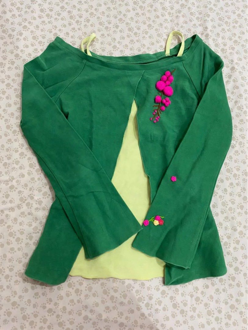 Green Top with Floral Embroidery (Category: Blouses) located in Santa Rosa. Submitted by honeyrackk (Listing ID 1433940135, Image 1). Description: - Green top with a unique design - Light yellow underlayer - Long sleeves - Pink floral embroidery on front and sleeves - Round neckline - Thin yellow straps - Adds a pop of color to any outfit.