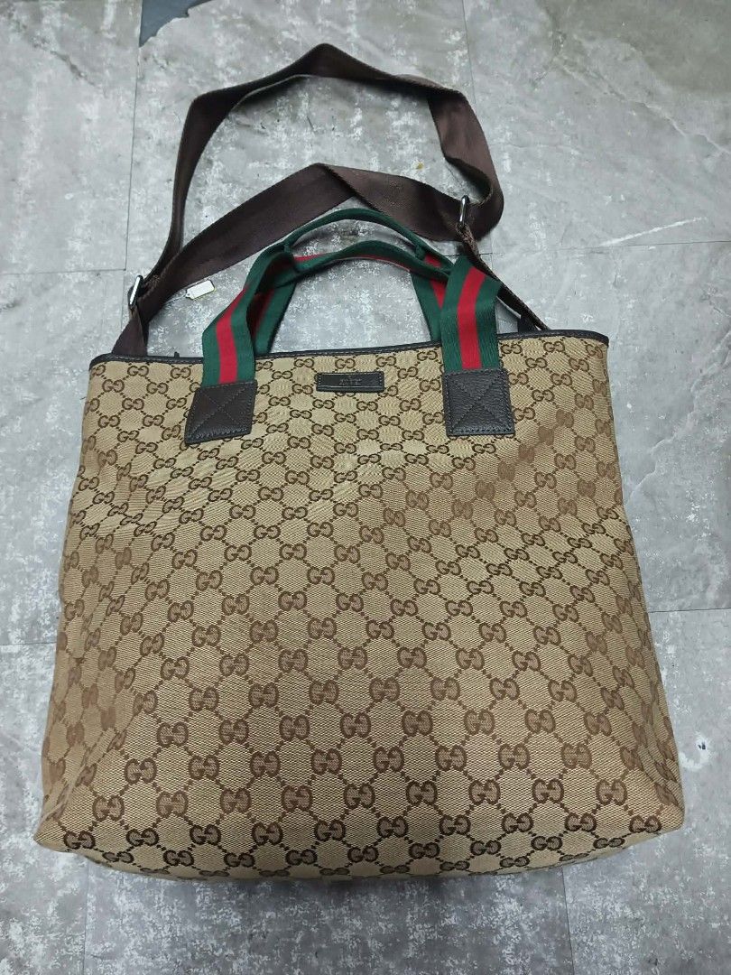Gucci GG Canvas Web Tote Bag (Category: Luxury Bags & Wallets) located in Baguio. Submitted by brandeditems16 (Listing ID 1433971872, Image 1). Description: - Authentic Gucci tote bag - Iconic GG canvas pattern - Brown leather trim - Green and red stripe on handles - Detachable shoulder strap - Spacious interior - Gucci logo zipper -Dustbag provided only .