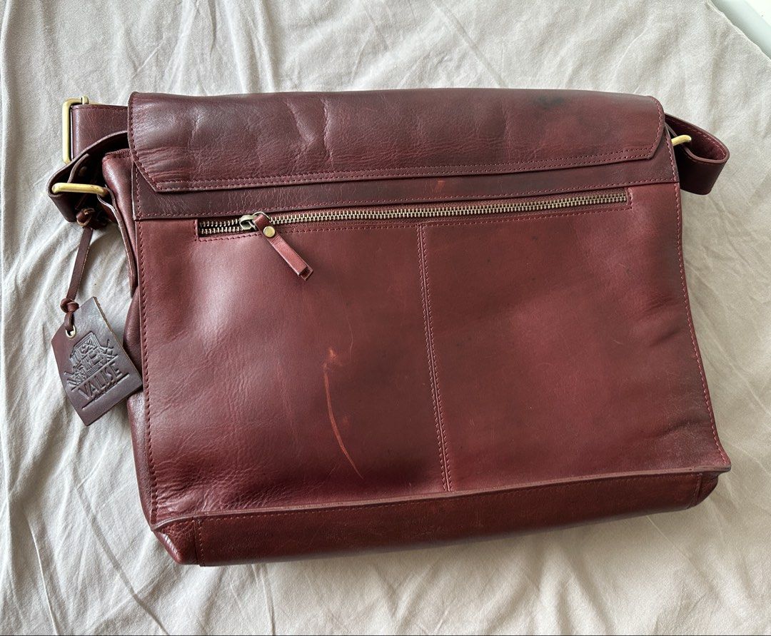 Leather Satchel Bag (Category: Sling Bags) located in Muntinlupa City. Submitted by emanuelthings (Listing ID 1433893567, Image 3). Description: - Valise genuine leather satchel bag - Cherry red exterior - Two front pockets - Secure flap closure with buckles - Plaid interior lining - Interior zippered pocket - Detachable shoulder strap - Spacious main compartment - Multiple pockets for organization.