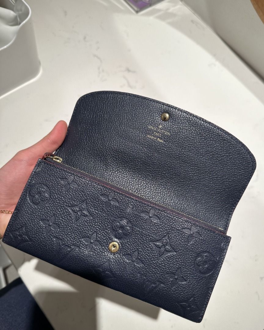 LOUIS VUITTON SAHARA WALLET (Category: Luxury Bags & Wallets) located in Quezon City. Submitted by cailincare94698 (Listing ID 1433820192, Image 3). Description: - Authentic Louis Vuitton Zippy Wallet - Navy blue with LV monogram - Red interior trim - Includes original box and dust bag - Button closure - Multiple card and cash compartments.