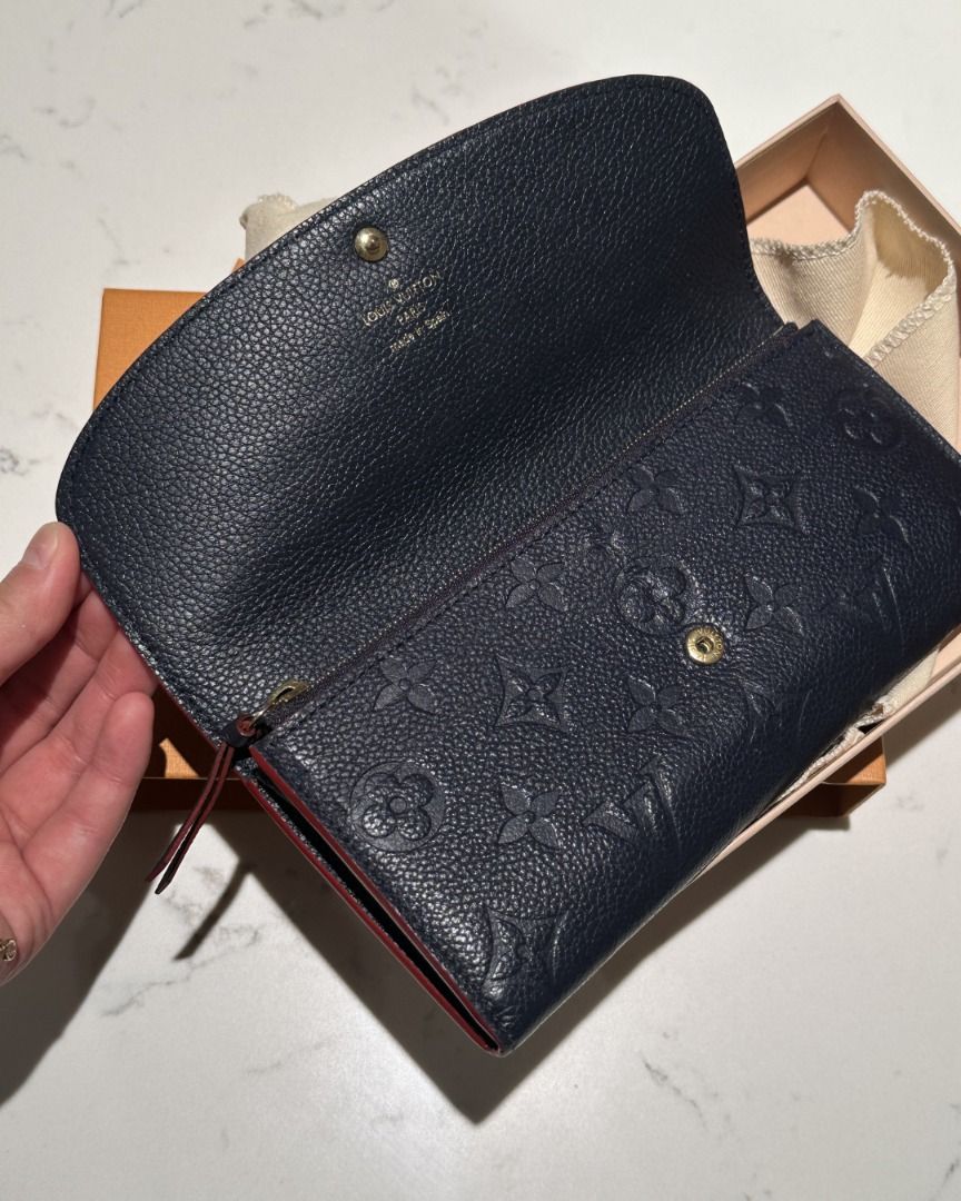 LOUIS VUITTON SAHARA WALLET (Category: Luxury Bags & Wallets) located in Quezon City. Submitted by cailincare94698 (Listing ID 1433820192, Image 2). Description: - Authentic Louis Vuitton Zippy Wallet - Navy blue with LV monogram - Red interior trim - Includes original box and dust bag - Button closure - Multiple card and cash compartments.