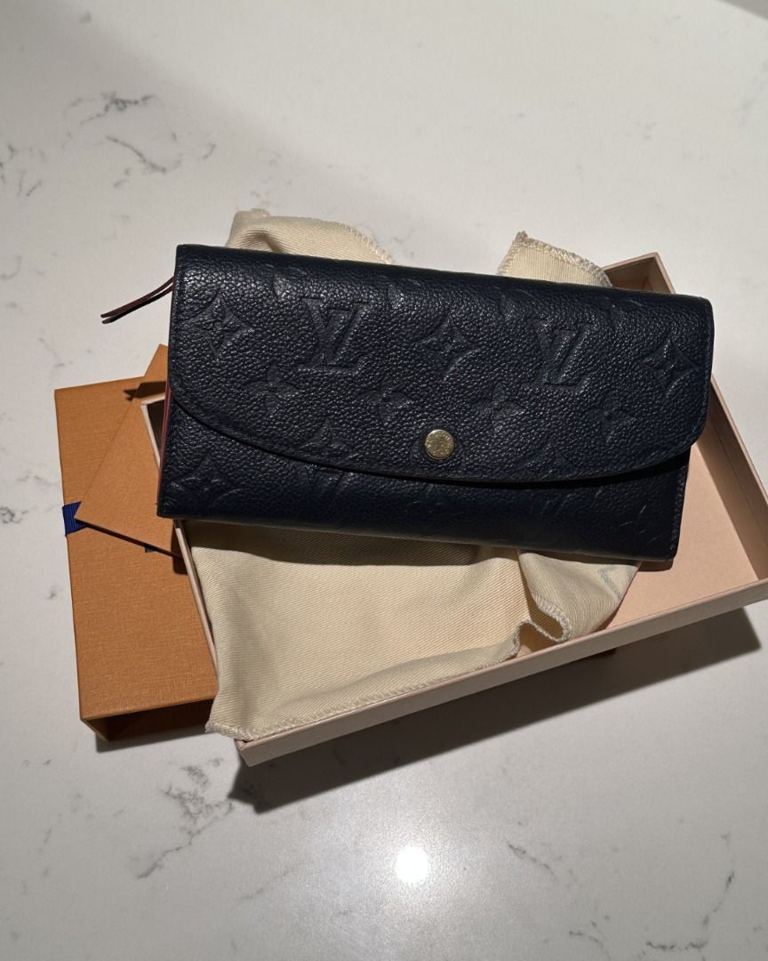 LOUIS VUITTON SAHARA WALLET (Category: Luxury Bags & Wallets) located in Quezon City. Submitted by cailincare94698 (Listing ID 1433820192, Image 1). Description: - Authentic Louis Vuitton Zippy Wallet - Navy blue with LV monogram - Red interior trim - Includes original box and dust bag - Button closure - Multiple card and cash compartments.