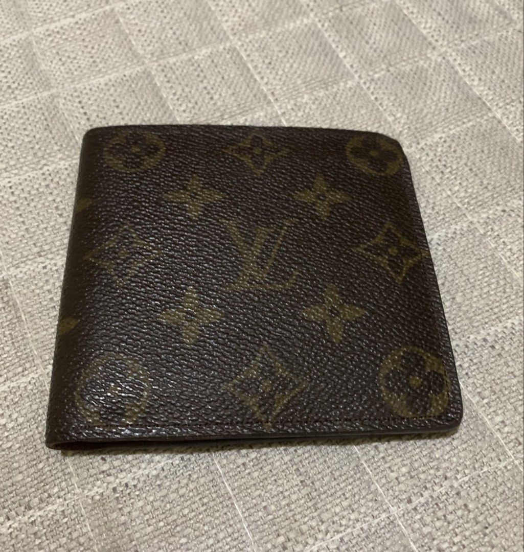 Louis Vuitton Monogram Wallet (Category: Luxury Bags & Wallets) located in Quezon City. Submitted by ncjnc (Listing ID 1433797890, Image 1). Description: - Authentic Louis Vuitton wallet - Classic Monogram pattern - Multiple card slots - Bill compartment - Light brown leather interior - Coin pocket with snap closure - Embossed "Louis Vuitton Paris Made in France".