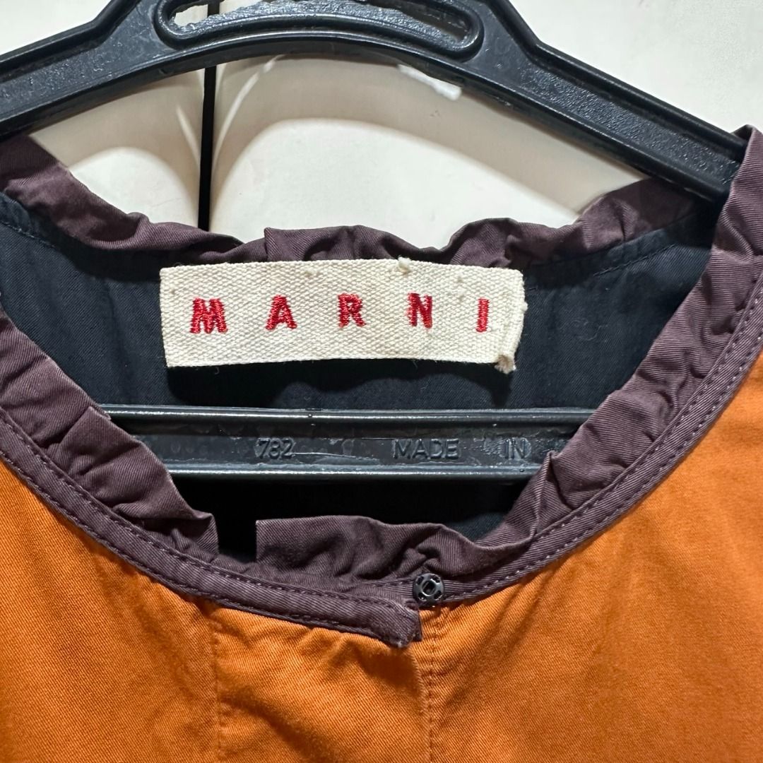 Marni - Rust Sleeveless Ruffle Summer Dress (Category: Dresses) located in Muntinlupa City. Submitted by pickjes (Listing ID 1433946719, Image 3). Description: Brand: Marni Size: Medium (42 on tag) Details: Sleeveless, ruffled empire waist, hidden button chest opening, dark brown around the neckline Material: 100% viscose Measurements: • Chest - 18 in • Length - 27.5 in Condition: Used with care. No flaws #womensfashion #fashion #marni #rust #ora