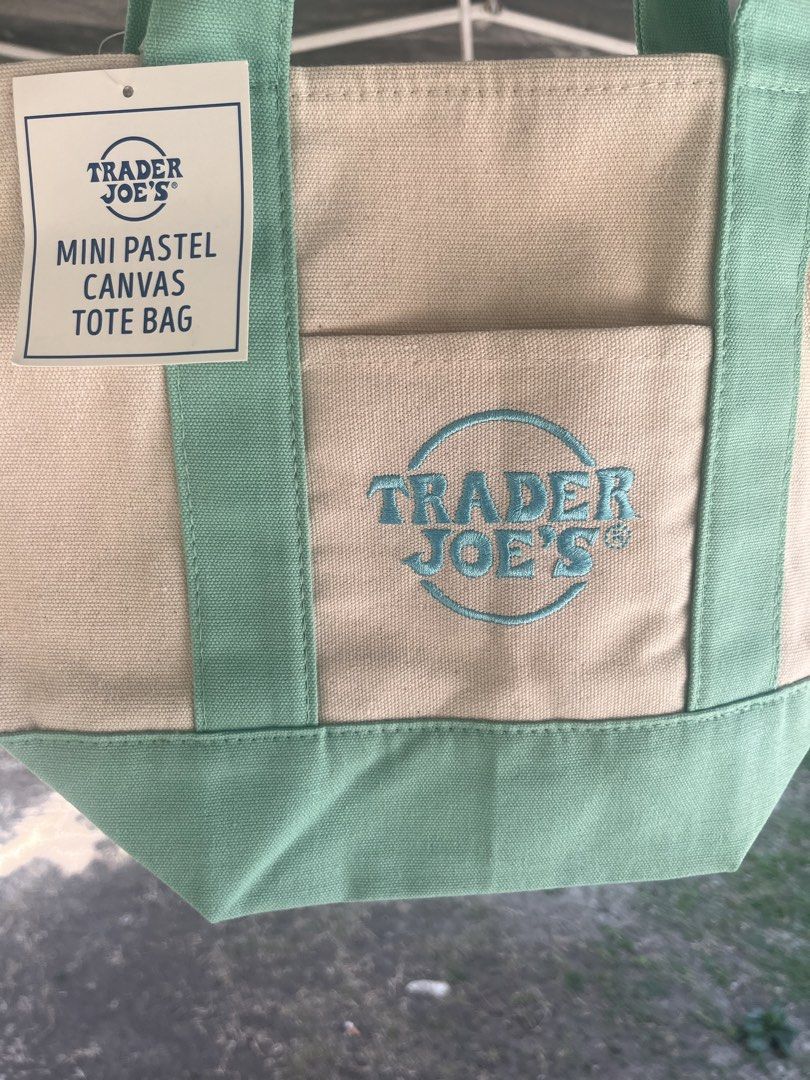 Original Trader Joe's Tote Bag (Category: Tote Bags) located in Lipa City. Submitted by coolthreadss (Listing ID 1433811502, Image 2). Description: Cute and stylish Trader Joe’s Mini Pastel Canvas Tote Bag. Made from durable canvas with a beige body and mint green handles and bottom. Perfect for daily use, quick errands, lunch bag, or small essentials. Lightweight but sturdy and very trendy. ✨ Brand: Trader Joe’s ✨ Material: Canvas ✨ Color: Beige