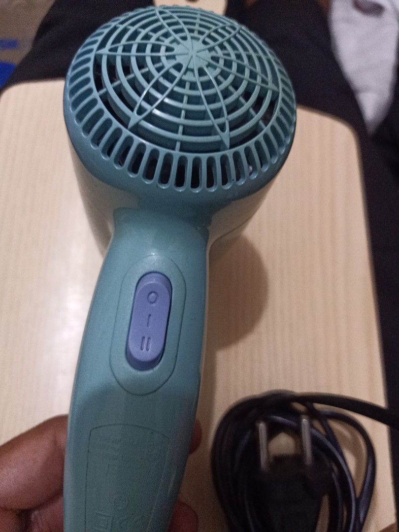 Philips Compact 1200 Hair Dryer (Category: Hair) located in Las Pinas. Submitted by the_recycle_shop (Listing ID 1433935555, Image 2). Description: - Philips Compact 1200 hair dryer - Teal color - Model: HP4915 - Power: 1200W, 220V - Two heat/speed settings - Compact design - Black power cord.