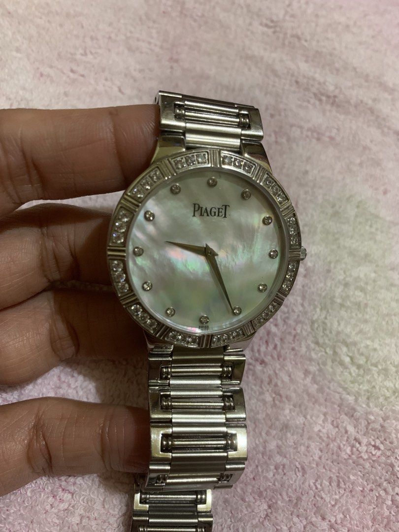 Piaget Diamond Watch (Category: Luxury Watches) located in Quezon City. Submitted by ncjnc (Listing ID 1433906396, Image 2). Description: - Piaget watch - Mother-of-pearl dial - Diamond accents - Stainless steel band and case - Classic round face design - Secure clasp - Piaget logo engraved on the back - Perfect for any occasion.