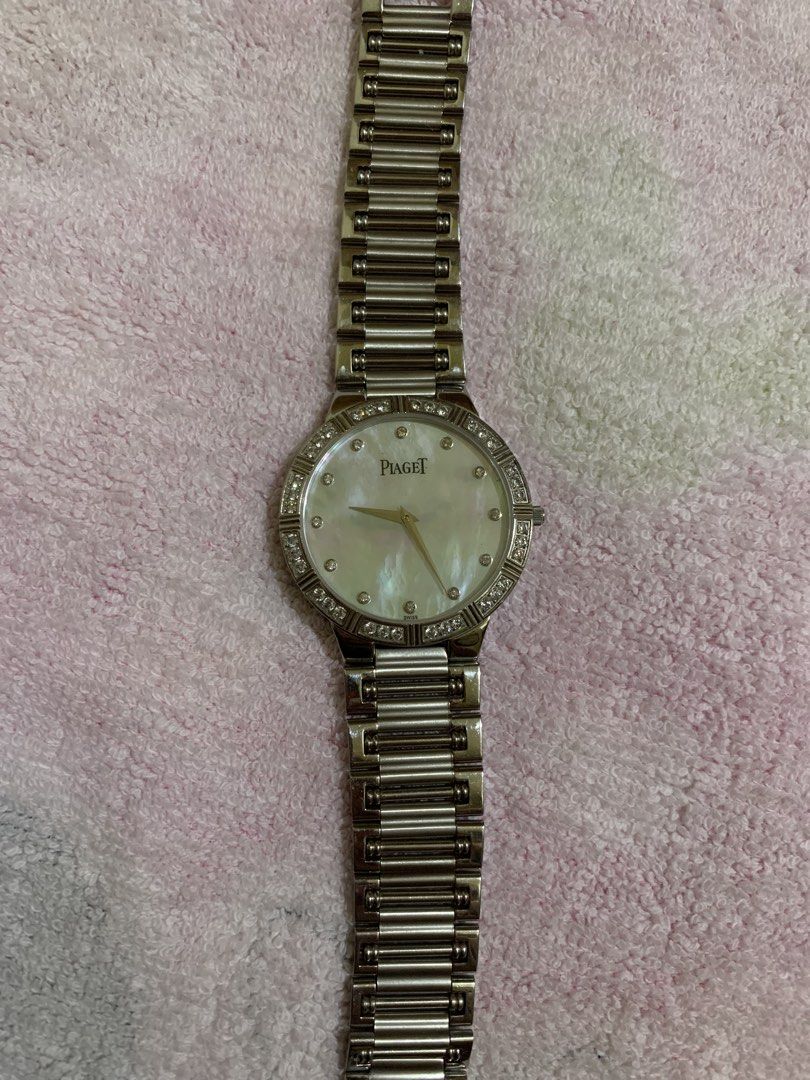 Piaget Diamond Watch (Category: Luxury Watches) located in Quezon City. Submitted by ncjnc (Listing ID 1433906396, Image 1). Description: - Piaget watch - Mother-of-pearl dial - Diamond accents - Stainless steel band and case - Classic round face design - Secure clasp - Piaget logo engraved on the back - Perfect for any occasion.