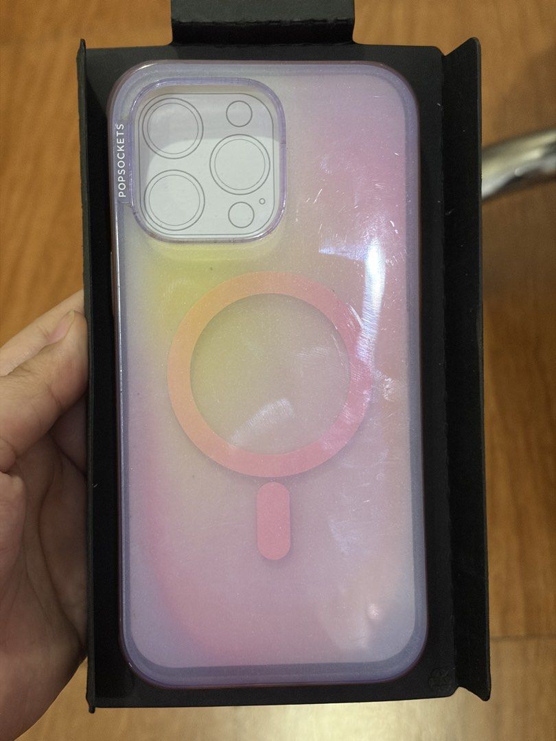 Popsocket case aura (Category: Cases & Sleeves) located in Quezon City. Submitted by stuffyy (Listing ID 1433788970, Image 2). Description: - Popsocket Aura Case - Designed for iPhone 14 Pro Max - Features an iridescent color - Made with plant-based materials - MagSafe compatible This is well used hence the price. The back part is very makinis.