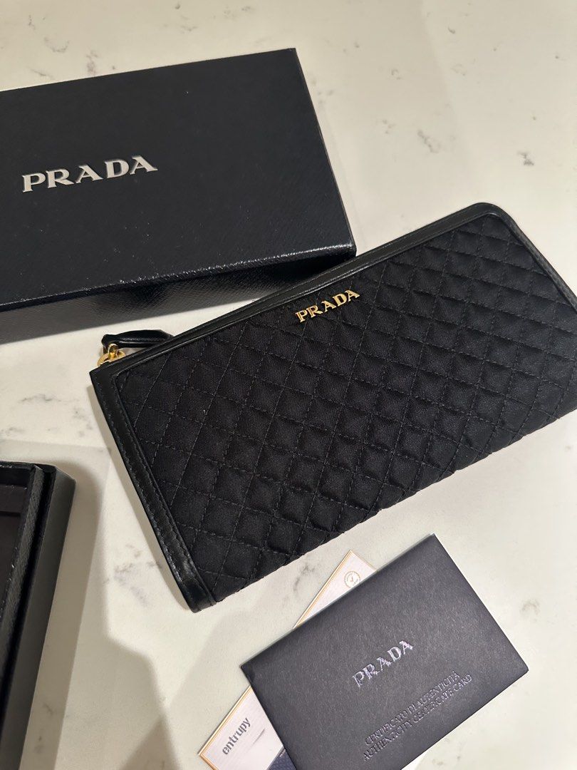 Prada Quilted Tessuto Wallet (Category: Luxury Bags & Wallets) located in Quezon City. Submitted by cailincare94698 (Listing ID 1433836848, Image 1). Description: - Like New - With Authentication Card - Zip Around Wallet - Quilted Black .