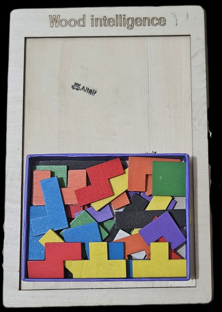 Russian Blocks or Tetris Puzzle (Category: Educational & Learning Toys) located in Makati City. Submitted by xzyche (Listing ID 1433921948, Image 1). Description: Purpose: Designed as an educational tool to cultivate spatial imagination, creativity, and hand-eye coordination. Gameplay: Users must fit all colorful pieces into the rectangular wooden frame without overlaps. Has stamps on it.
