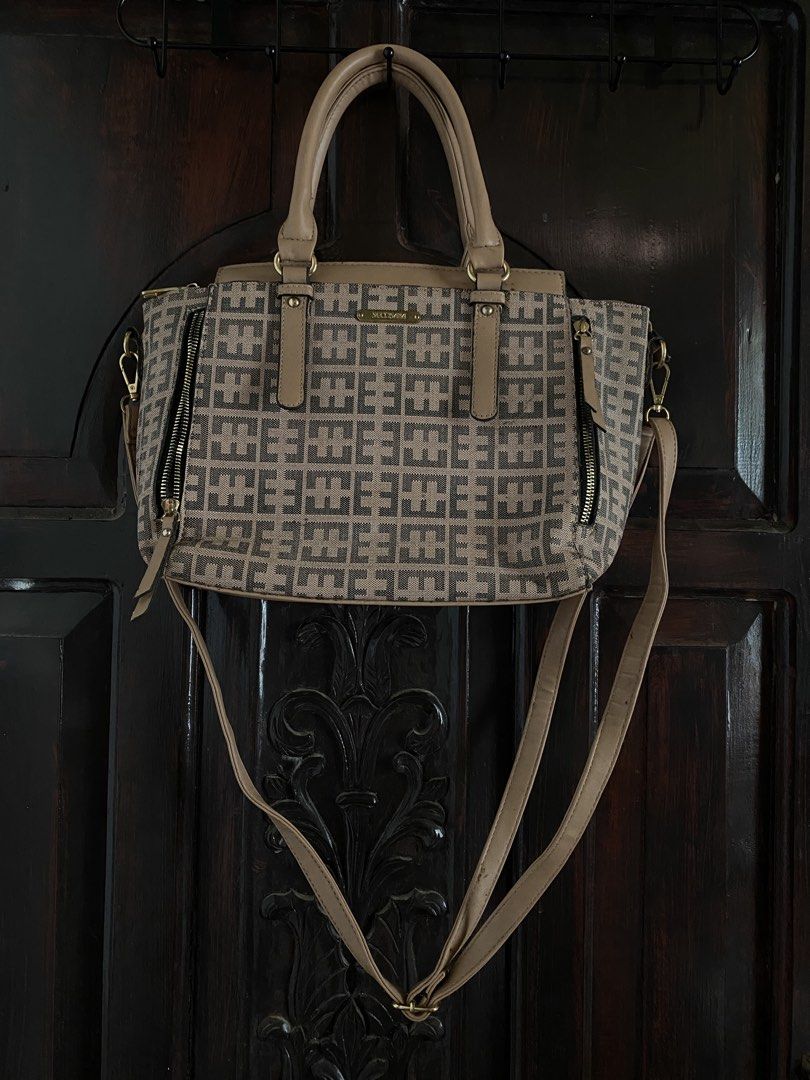 Secosana Brown Handbag with Shoulder Strap Two way Sling (Category: Shoulder Bags) located in Iloilo. Submitted by cbd222 (Listing ID 1433813019, Image 1). Description: - Tan and brown geometric patterned handbag - Includes two handles and a detachable shoulder strap - Features side zippers and a top zipper.