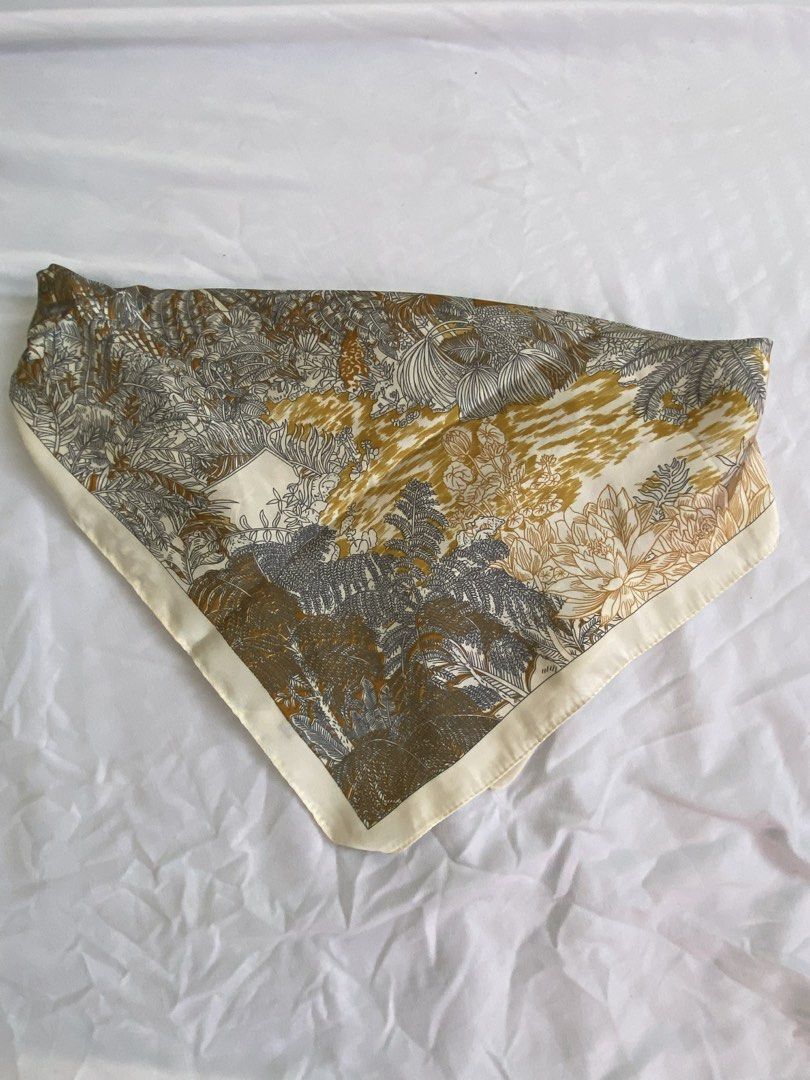 Silk Scarf with Floral Print (Category: Scarves) located in Manila. Submitted by cstdjyc (Listing ID 1433937585, Image 1). Description: - Silk scarf with a beautiful floral design. - Colors: Green, gold, and cream. - Features a cream-colored border. - Made of smooth, lightweight material. - Square-shaped. - Adds a touch of sophistication to any outfit..