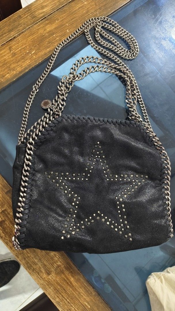 Stella McCartney Falabella Star Bag ORIGINAL (Category: Luxury Bags & Wallets) located in Bacoor. Submitted by ourpersonalstuffs (Listing ID 1433790059, Image 1). Description: - Black Stella McCartney Falabella bag - Star design - Chain strap and chain detailing - Magnetic snap closure - Interior pocket - Branded lining - Interior tag code: 234387 W9132 -Limited Edition .