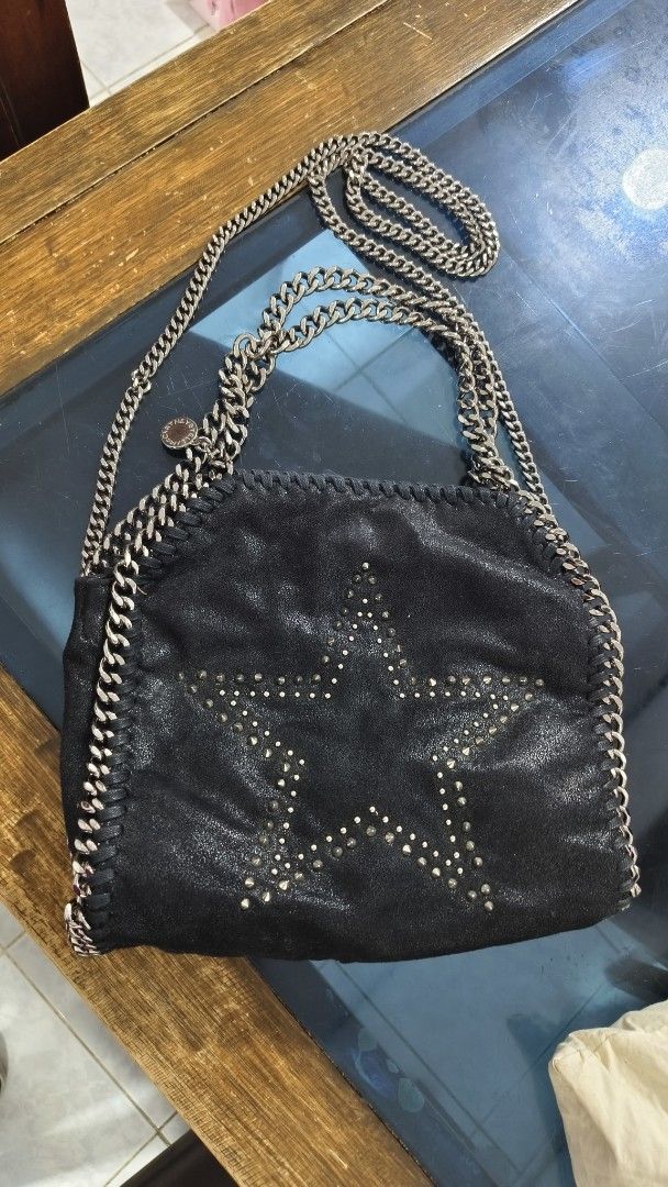 Stella McCartney Falabella Star Bag ORIGINAL (Category: Luxury Bags & Wallets) located in Bacoor. Submitted by ourpersonalstuffs (Listing ID 1433790059, Image 2). Description: - Black Stella McCartney Falabella bag - Star design - Chain strap and chain detailing - Magnetic snap closure - Interior pocket - Branded lining - Interior tag code: 234387 W9132 -Limited Edition .