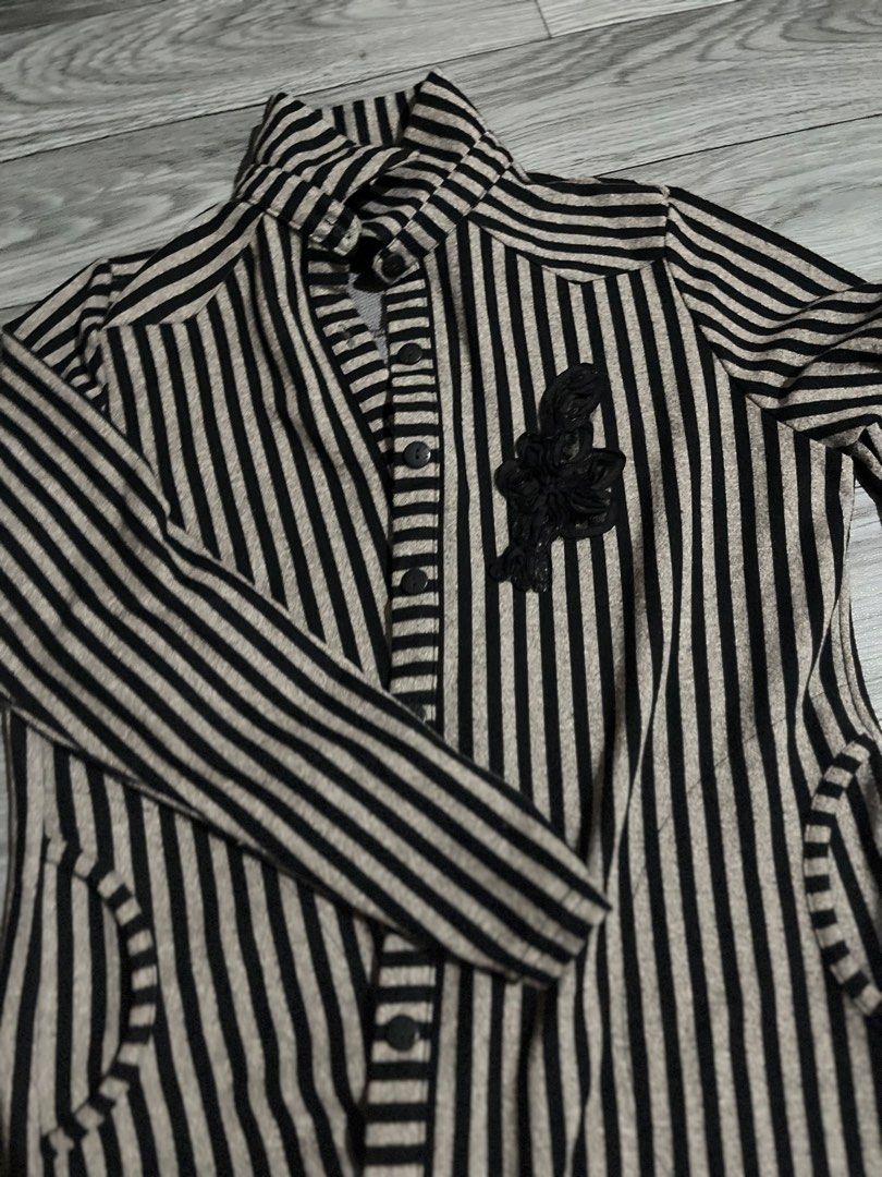Striped Long Sleeve Shirt (Category: Tshirts & Polo Shirts ) located in Pasig City. Submitted by anya2000 (Listing ID 1433898118, Image 2). Description: - Long sleeve shirt - Vertical black and beige stripes - High collar - Button-down front - Two pockets - Decorative black applique on chest - Textured fabric -xl tag but can fit to medium ppl.