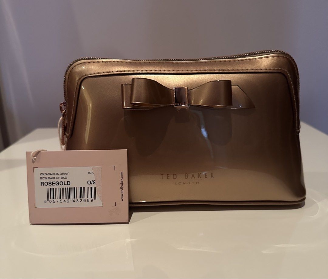 Ted Baker Rose Gold Bow Makeup Bag (Category: Purses & Pouches) located in Manila. Submitted by caseller26 (Listing ID 1433883305, Image 2). Description: - Ted Baker Bow Makeup Bag - Rose Gold finish - Decorative bow detail - Zip closure - Includes tag - Size: O/S - With slight white marks on the bottom.
