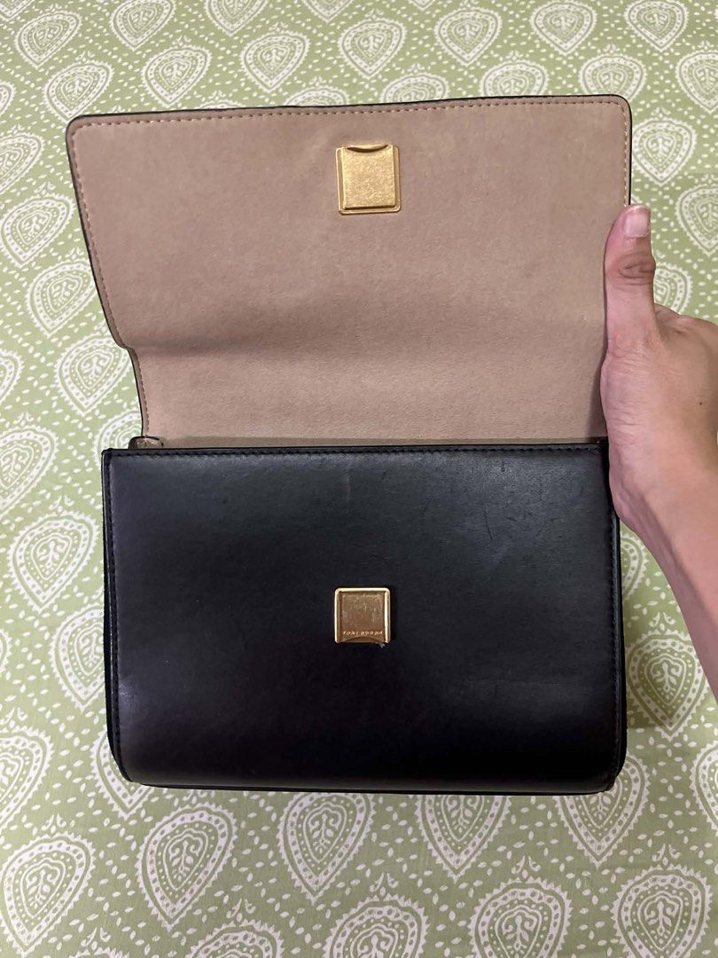 Tory Burch Black Leather Handbag/bodybag (Category: Luxury Bags & Wallets) located in Quezon City. Submitted by shoptillyoudrop777 (Listing ID 1433919235, Image 3). Description: - Black leather handbag - Top handle and detachable shoulder strap - Gold-tone logo - Zip closure - Light-colored interior lining - Small interior pocket - Made in Cambodia - Signs of usage - Bought at outlet store.