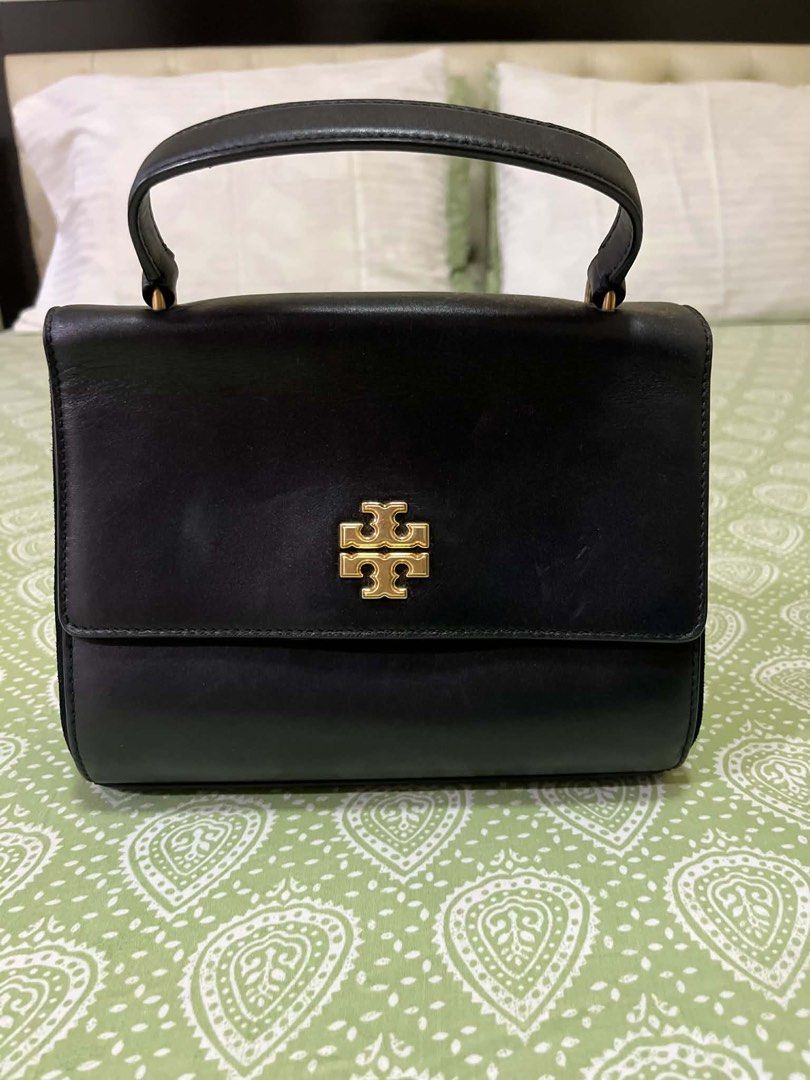 Tory Burch Black Leather Handbag/bodybag (Category: Luxury Bags & Wallets) located in Quezon City. Submitted by shoptillyoudrop777 (Listing ID 1433919235, Image 1). Description: - Black leather handbag - Top handle and detachable shoulder strap - Gold-tone logo - Zip closure - Light-colored interior lining - Small interior pocket - Made in Cambodia - Signs of usage - Bought at outlet store.
