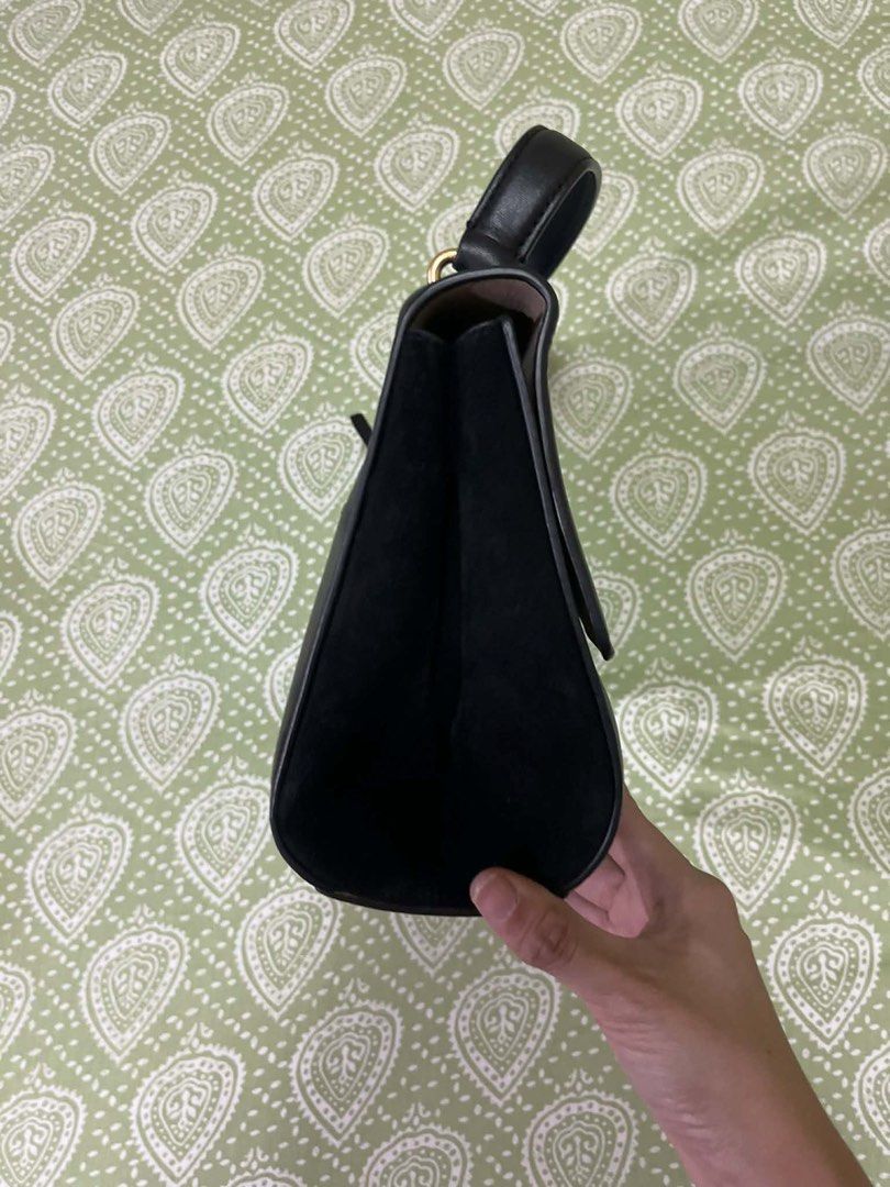 Tory Burch Black Leather Handbag/bodybag (Category: Luxury Bags & Wallets) located in Quezon City. Submitted by shoptillyoudrop777 (Listing ID 1433919235, Image 2). Description: - Black leather handbag - Top handle and detachable shoulder strap - Gold-tone logo - Zip closure - Light-colored interior lining - Small interior pocket - Made in Cambodia - Signs of usage - Bought at outlet store.