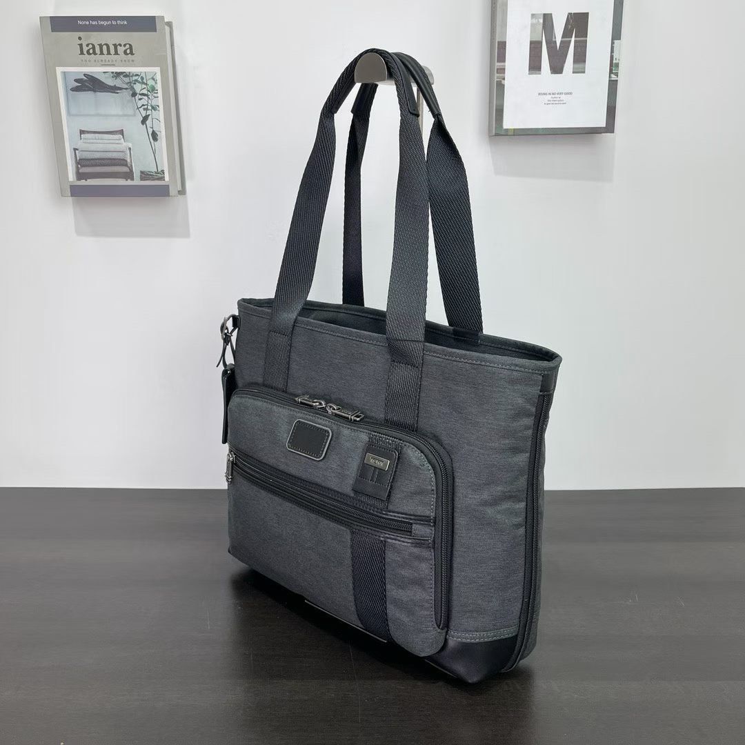 Tumi East West Tote Bag (Category: Tote Bags) located in Manila. Submitted by bagmaniaph (Listing ID 1433943374, Image 2). Description: A spacious tote crafted from durable polyester makes the perfect travel companion for your next weekend getaway. A smart Add-a-Bag strap means you can easily attach it to the handle of a rolling suitcase for added convenience..
