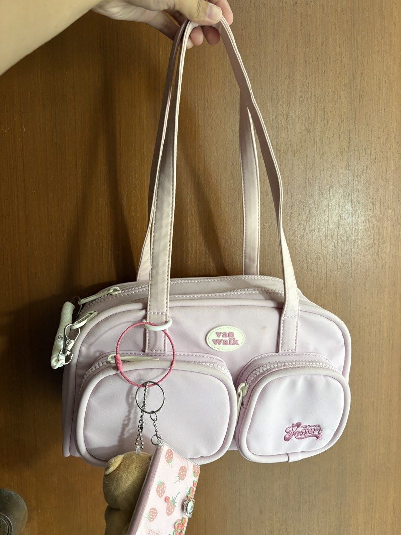 Van Walk Pink Shoulder Bag (Category: Shoulder Bags) located in Naga. Submitted by _declutterbym_ (Listing ID 1433929876, Image 1). Description: - Pink shoulder bag - Two front pockets - Top zipper closure - "Van Walk" logo - Includes keychain - Back zipper - Two handles.