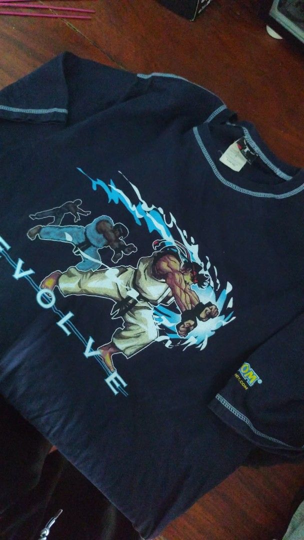 Vintage Shirts (Category: Tshirts & Polo Shirts ) located in Puerto Princesa. Submitted by secondhand_bliss (Listing ID 1433920008, Image 2). Description: Dark blue vintage t-shirt featuring a skull with a dragon graphic and flames. The shirt has a crew neck and short sleeves. The graphic is centered on the back of the shirt..