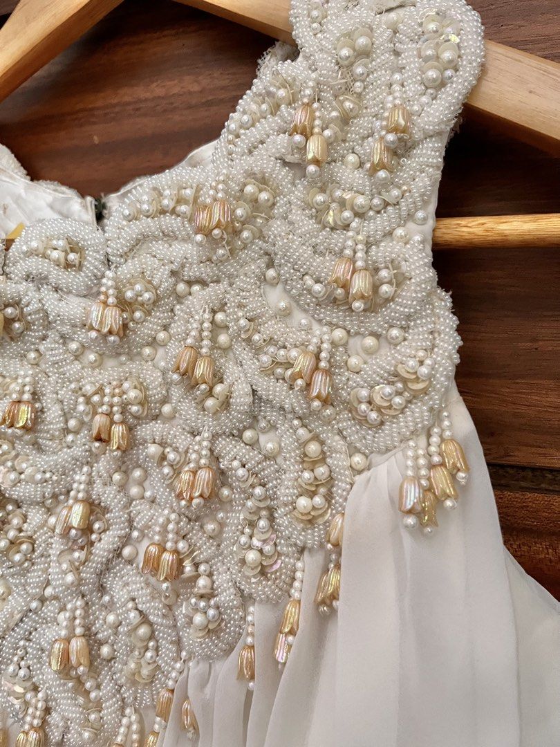Vintage white flowy beaded dress (Category: Evening dresses & gowns) located in Quezon City. Submitted by junkstar2020 (Listing ID 1433833193, Image 2). Description: Vintage 70s white flowy dress with beaded bib. Chiffon overlay on stiff paperlike lining. US size 0-2 Chest 28 inches Armhole circumference 16 inches Length 56 inches.