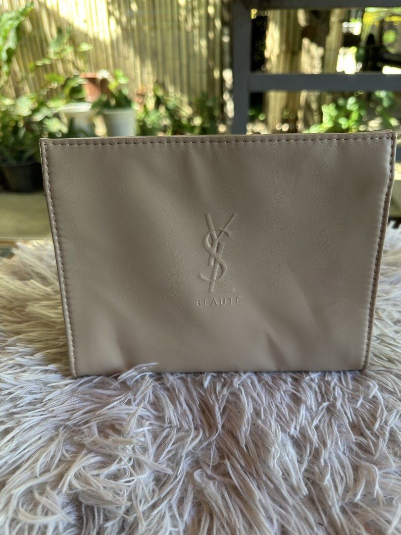 YSL Beauté Cosmetic Pouch (Category: Luxury Bags & Wallets) located in Digos. Submitted by venusacaro13427 (Listing ID 1433794767, Image 1). Description: - Authentic YSL Beauté cosmetic pouch. - Stylish beige exterior. - Secure snap closure. - Features the iconic YSL logo. - Black interior with a printed message. - Perfect for makeup and small items..