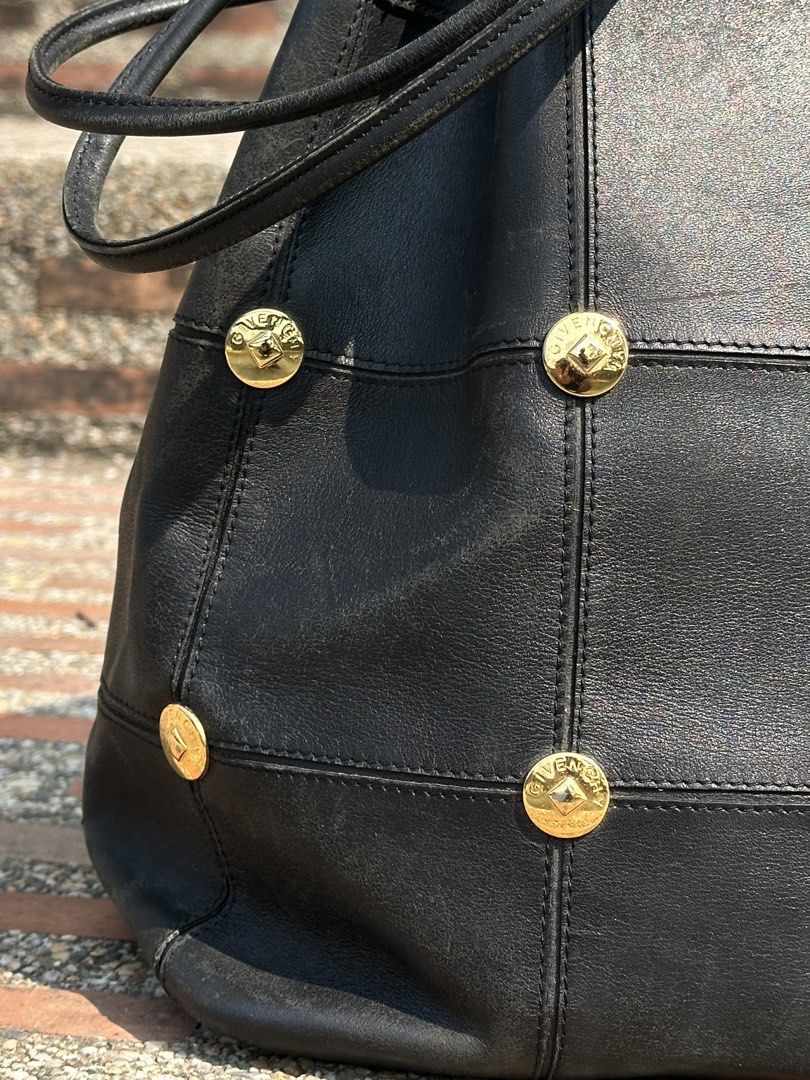 90's GIVENCHY Studded Leather Bucket Bag with Pouch (Category: Luxury Bags & Wallets) located in Urdaneta. Submitted by redeemedcollective (Listing ID 1434074084, Image 2). Description: Rare archival Givenchy! A stunning "quiet luxury" piece in buttery black leather with gold-tone hardware. • Details: Iconic Givenchy-engraved studs, paneled leather construction, and drawstring closure. • Inclusions: Comes with the original matching leather zip po