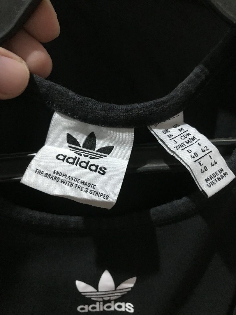 Adidas Adicolor Essentials Rib Tank Dress (Category: Dresses) located in Manaoag. Submitted by love.abgl (Listing ID 1434101121, Image 3). Description: - Adidas tank dress in black - Features the Adidas trefoil logo - Sleeveless design - Bodycon fit - Size: UK 14, J COM 38, F 42 - Made in Vietnam - Soft, stretchy material.