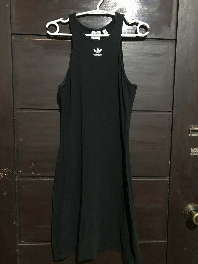 Adidas Adicolor Essentials Rib Tank Dress (Category: Dresses) located in Manaoag. Submitted by love.abgl (Listing ID 1434101121, Image 2). Description: - Adidas tank dress in black - Features the Adidas trefoil logo - Sleeveless design - Bodycon fit - Size: UK 14, J COM 38, F 42 - Made in Vietnam - Soft, stretchy material.