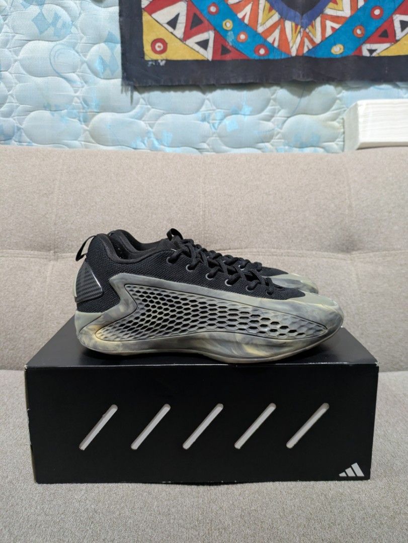 Adidas AE 1 Low Black (Category: Sneakers) located in Manila. Submitted by neo921 (Listing ID 1434088409, Image 1). Description: - Adidas AE 1 Low sneakers - Color: Black - Includes original box with Adidas and Anthony Edwards logos - Size indicated on box - Soles show wear - Features a unique mesh-like design on the sides.