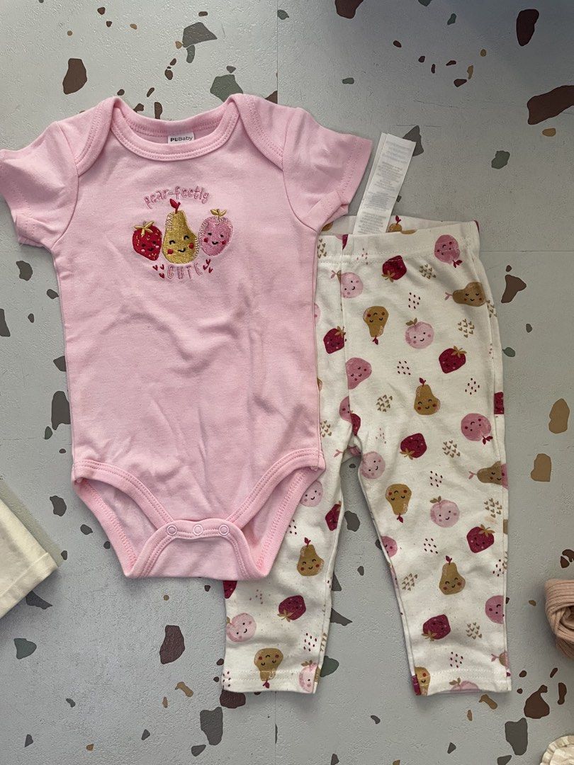 Baby Bodysuit and Pants Set (Category: Babies & Kids Fashion) located in Mandaluyong City. Submitted by randomrom (Listing ID 1434026954, Image 1). Description: - Features a pink bodysuit with a cute fruit design. - Matching pants with a fun fruit pattern. Runs small.