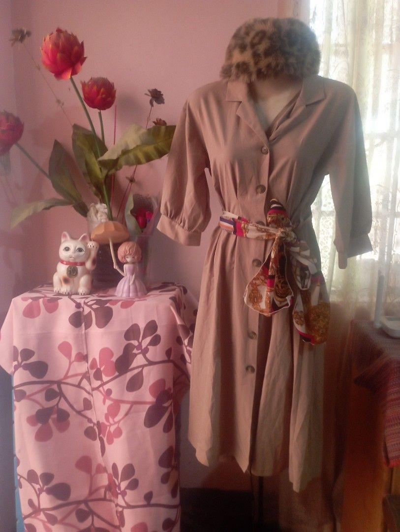 Beige Trench Coat with Belt (Category: Dresses) located in Manila. Submitted by Jessane23 (Listing ID 1434100099, Image 2). Description: - Elegant beige trench coat - Double-breasted design - Button closures - Matching belt with patterned scarf - Long sleeves - Classic trench coat silhouette - Adds sophistication.