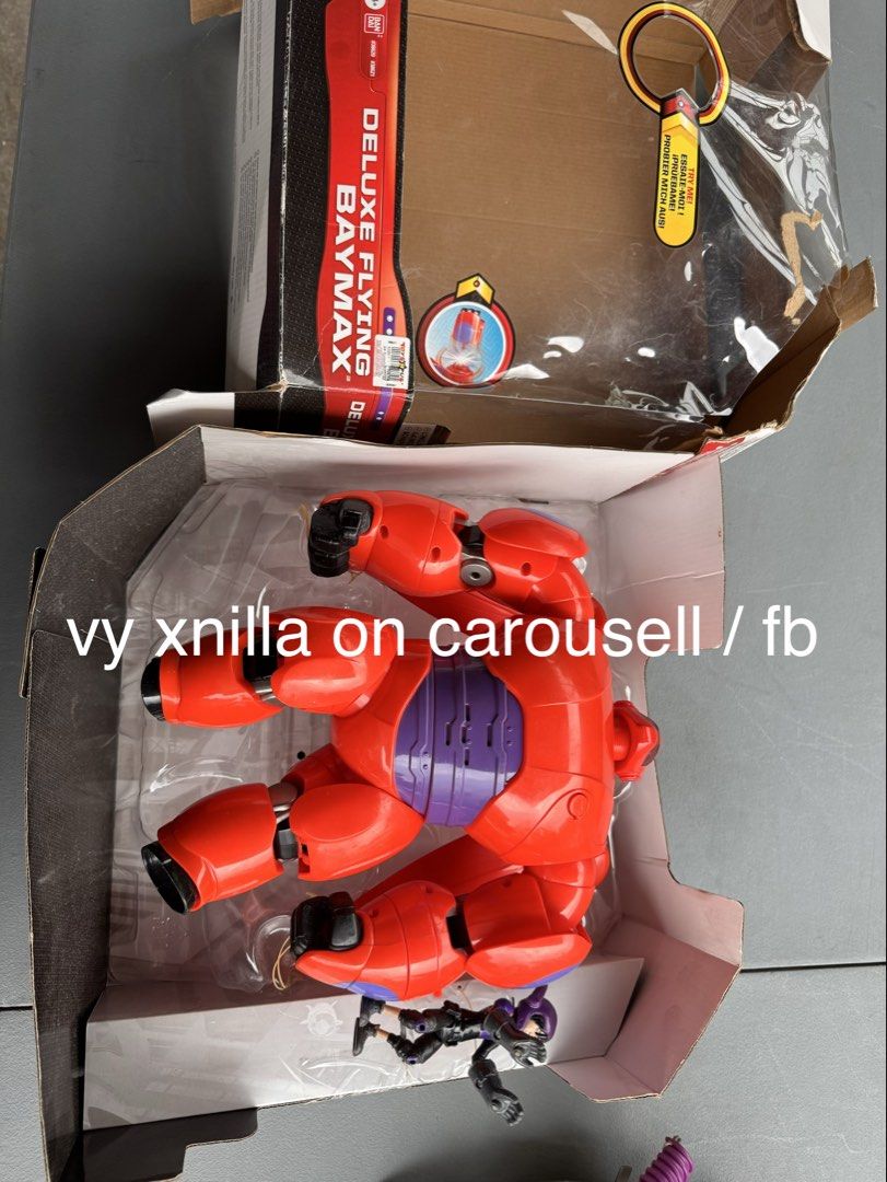 Big Hero 6 Deluxe Flying Baymax (Category: Figurines & Statues) located in Manila. Submitted by vyxcart (Listing ID 1433982772, Image 2). Description: - Big Hero 6 Deluxe Flying Baymax action figure - Includes Baymax figure (red and purple) and Hiro Hamada figure - Item is in original packaging - Box is visible in the images.