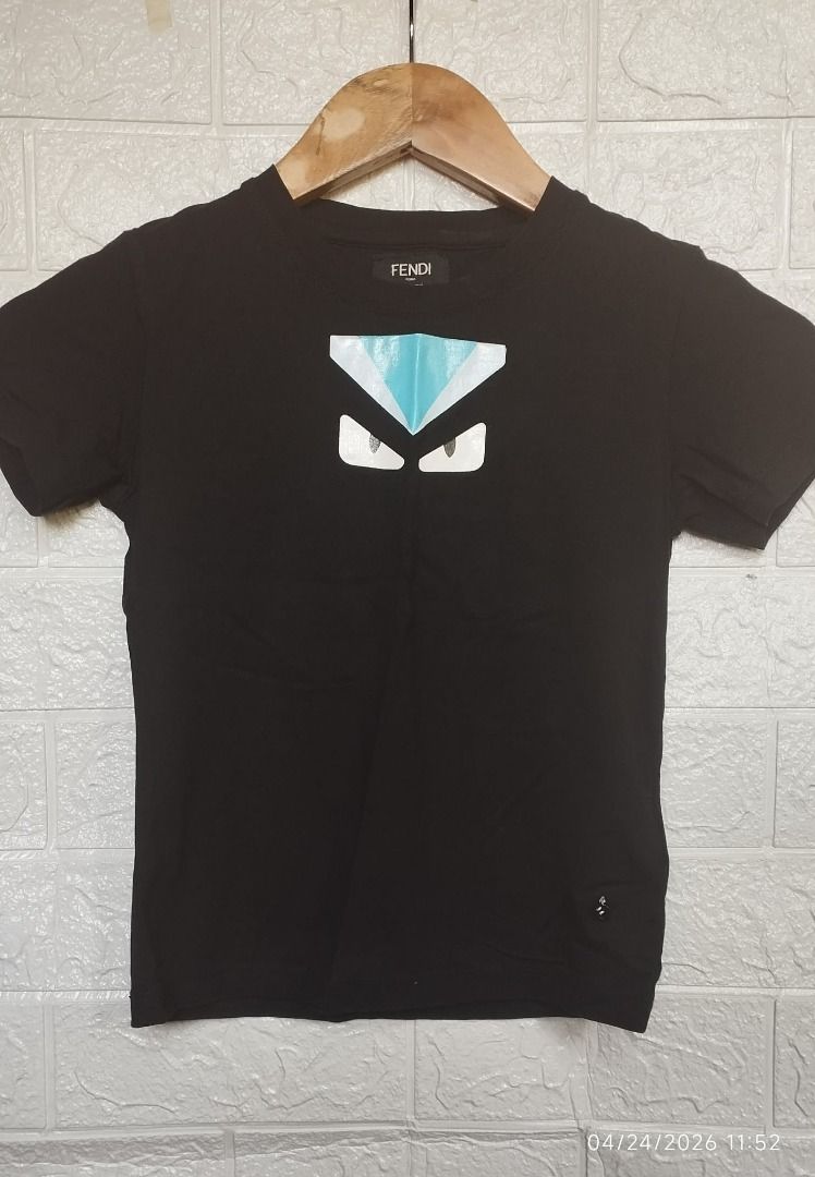 Black Fendi-Inspired Monster Eye Tee (Category: Babies & Kids Fashion) located in Los Banos. Submitted by wise-fox27 (Listing ID 1434027658, Image 1). Description: Give him a high-fashion edge with this black graphic tee featuring the iconic "monster eyes" design in a cool blue gradient. Sleek, comfortable, and perfect for a mini-streetwear look. Condition: Preloved Style: Streetwear / Designer Inspired Measurement: Chest: 13.5in Length: 17.5in T