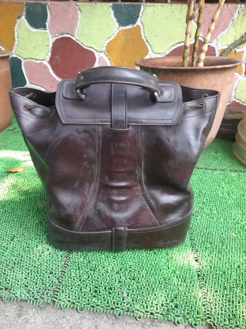Bowling leather bag 1300 (Category: Luxury Bags & Wallets) located in Valenzuela. Submitted by newbear.425b6e (Listing ID 1434004474, Image 3). Description: - Dark brown leather bucket bag - Top handle and buckle closure - Drawstring closure at the top - Circular base interior - Interior lining has a tear -issue Worn appearance -bowling leather bag japan surplus.