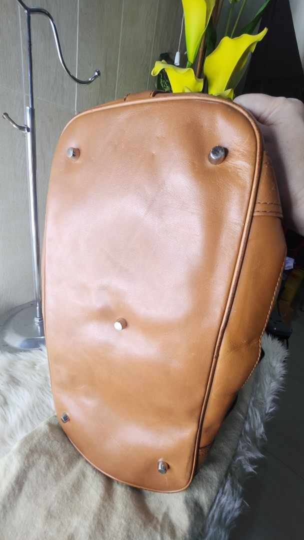 Burberry Leather Handbag (Category: Luxury Bags & Wallets) located in Cavite. Submitted by geturs (Listing ID 1433978823, Image 3). Description: - Authentic Burberry handbag - Tan leather exterior - Classic Burberry check interior - Includes dust bag - Structured design with multiple compartments - Secure buckle closures - Sturdy handles - Metal hardware - Perfect for everyday use NOTE: bag is slightly heavy due to leather and buckles.