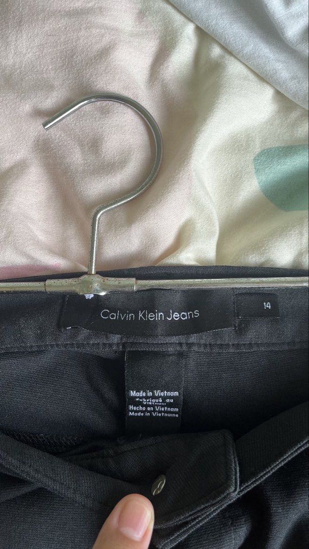 Calvin Klein Jeans Black Pants Size 14 (Category: Jeans) located in Pasig City. Submitted by detneedsmoney (Listing ID 1434033130, Image 2). Description: Black Calvin Klein Jeans pants. Size 14. Made in Vietnam. Waist measures approximately 17 inches across. Inseam is about 35 inches. The hem is approximately 6 inches. Features a button closure and pockets. A classic and versatile addition to your wardrobe..